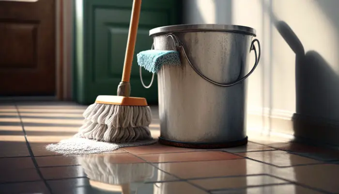 Mopping bathroom floor with bleach and water solution