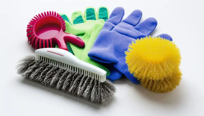 Scrub brush and protective gloves for cleaning bathtub with toilet bowl cleaner