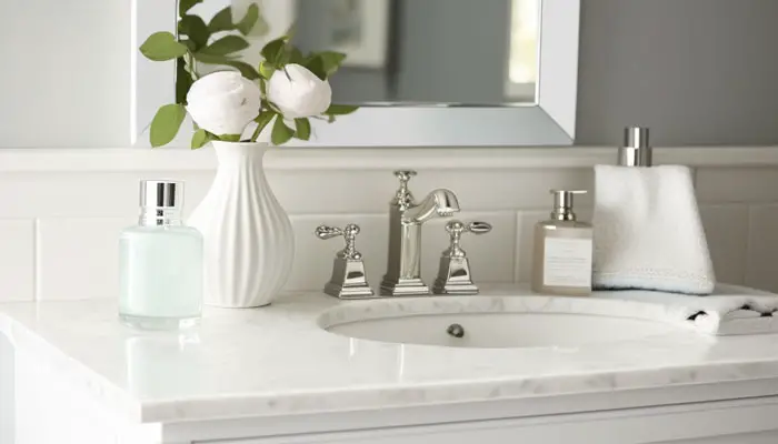 Scrubbing a porcelain bathroom sink to remove hair dye stains