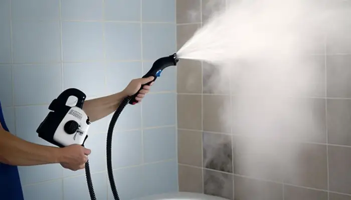 Using steam cleaning machine to clean textured shower walls