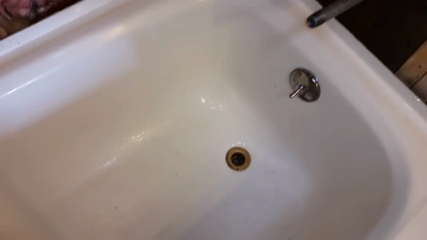 Is it Safe to Use Chemicals to Remove Adhesive on a Fiberglass Tub Surface