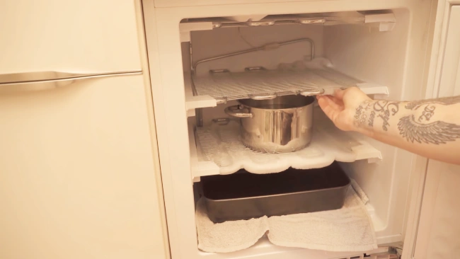 What causes a Frigidaire freezer defrost drain to freeze
